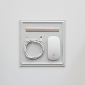 a white rectangular object with a silver circle on it