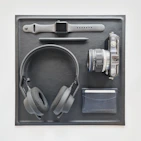 Flat lay of Pulseforge accessories including water bottle, gym gloves, and headband on white background