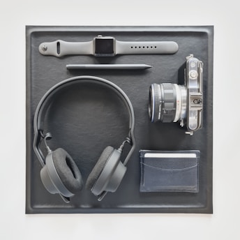 A vibrant flat lay of a smartwatch, headphones, and a trendy jacket on a bright background.