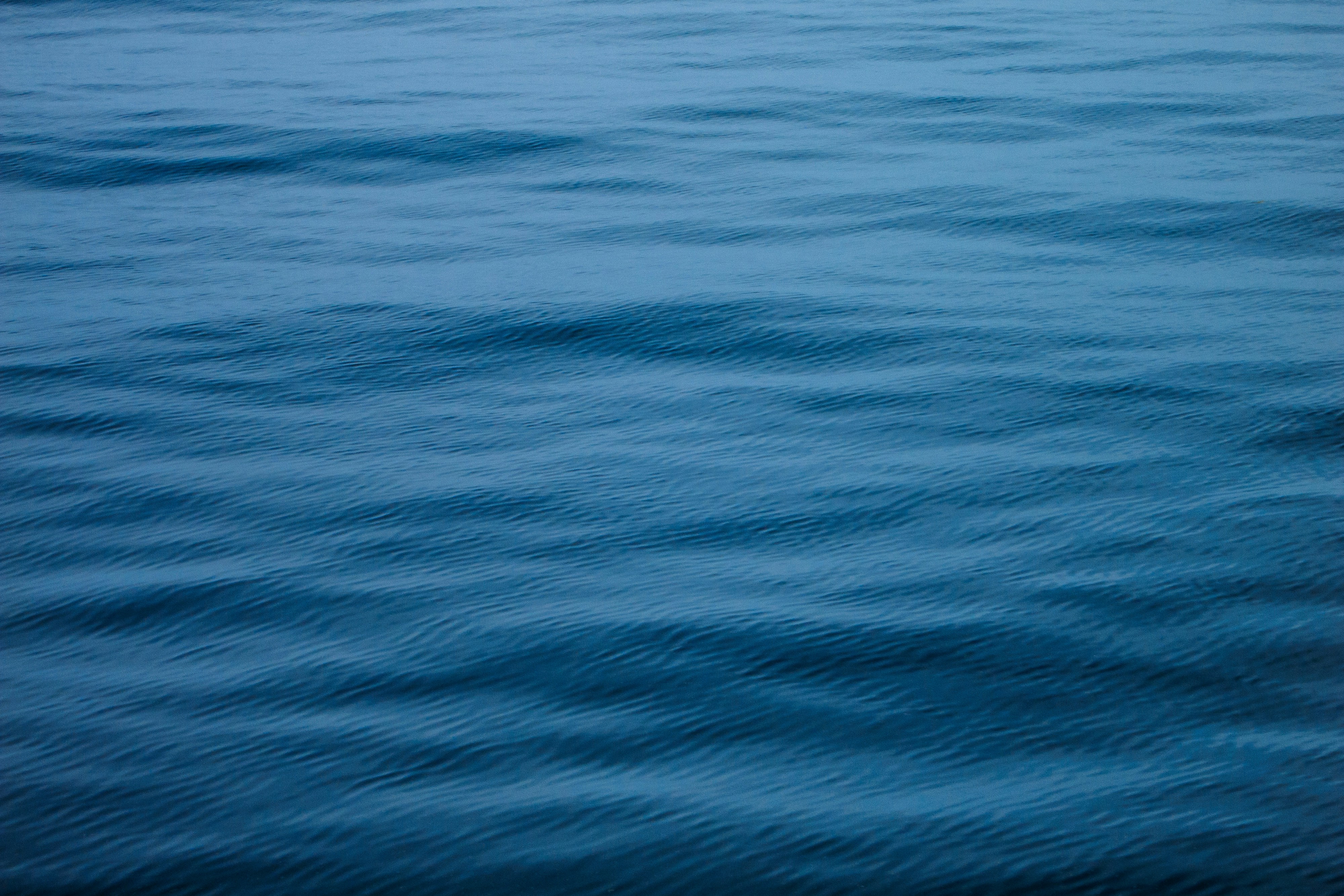 woman wearing yellow long-sleeved dress under white clouds and blue sky during daytime