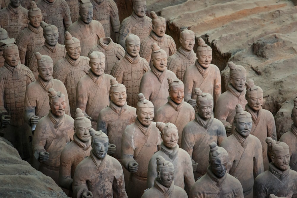 a group of men in a circle with Terracotta Army in the background