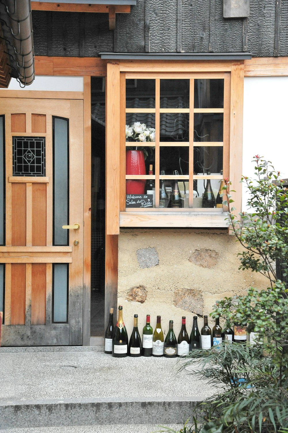 a window with bottles of wine in front of it