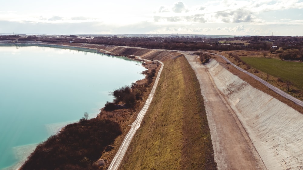 a road next to a body of water