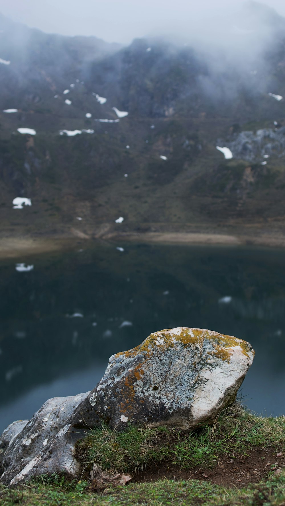 a body of water with mountains in the background