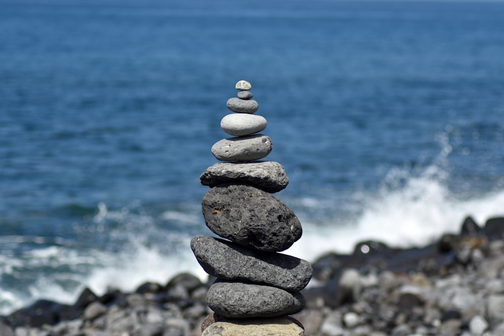 a stack of rocks by the water