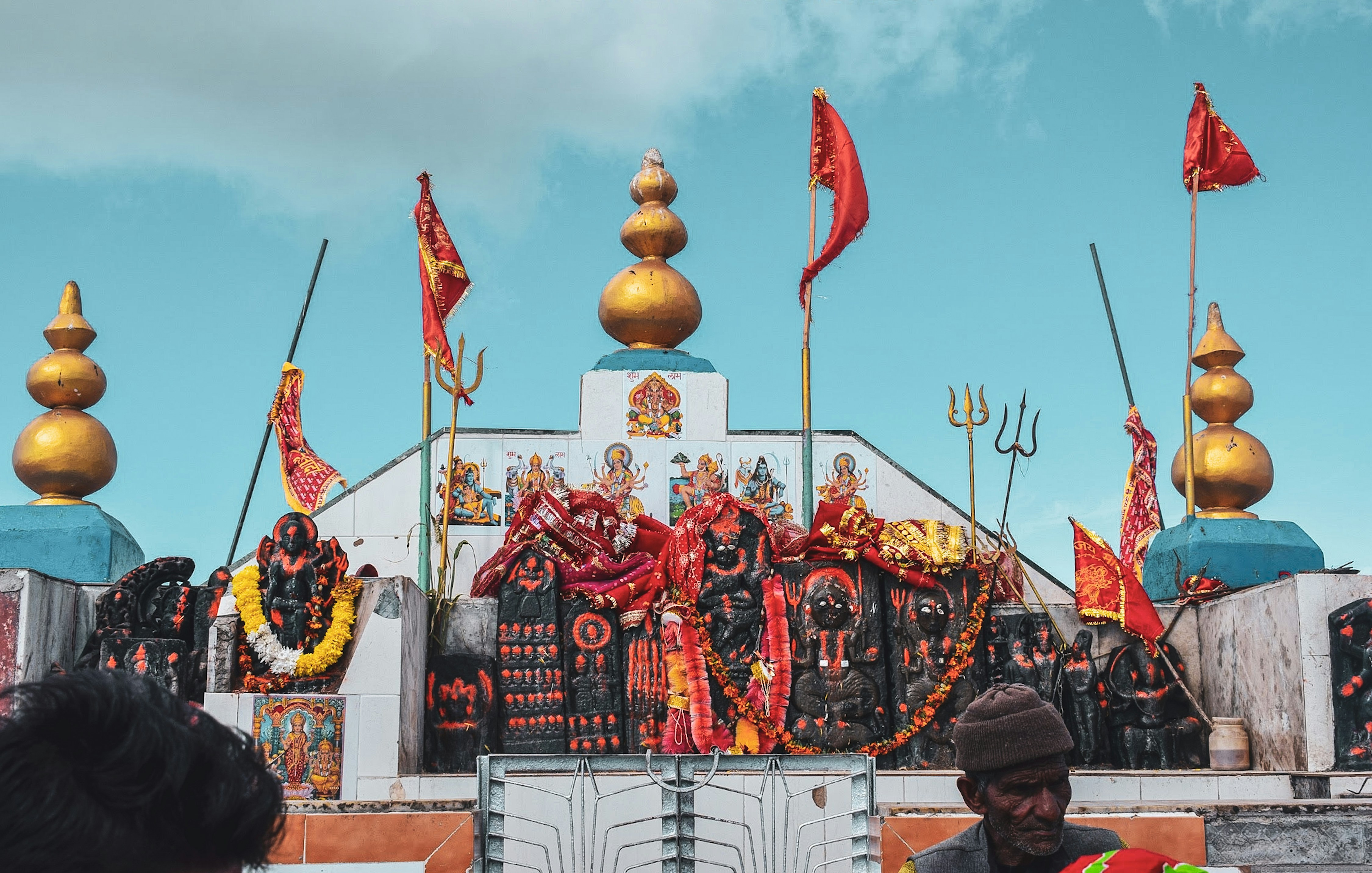 a group of people in front of a building with flags