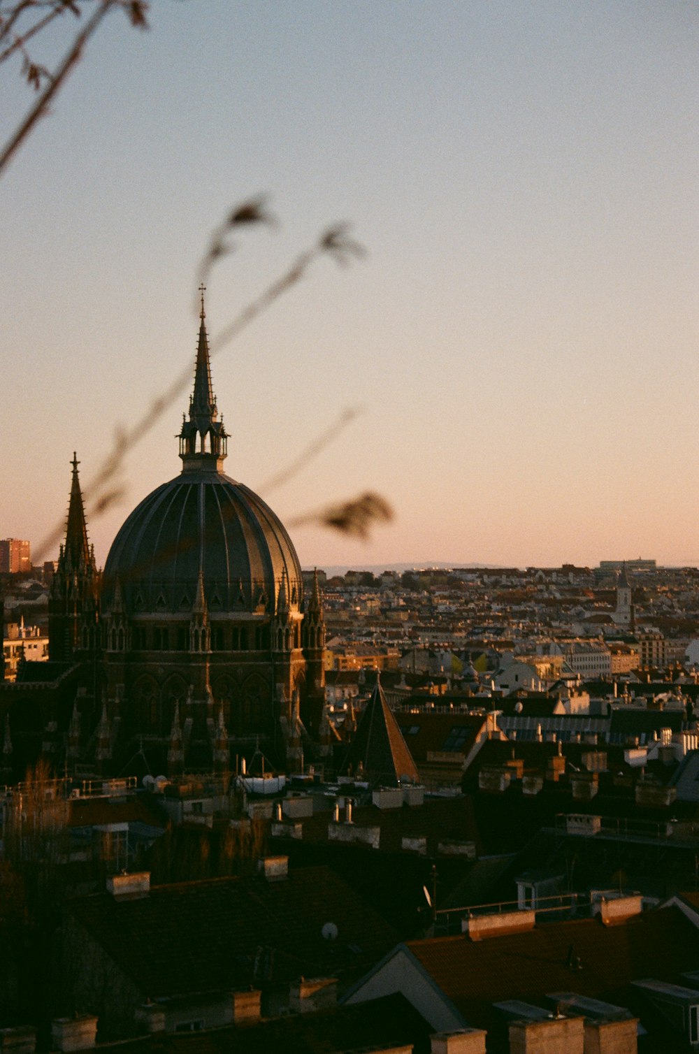 a large building with a dome on top with a city below