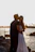 A happy family embracing on the Malecón in Havana at sunset.