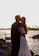 A happy family embracing on the Malecón in Havana at sunset.