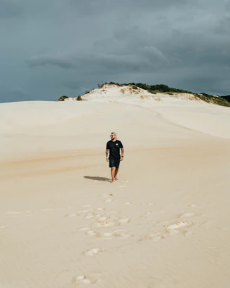 a person standing in the sand