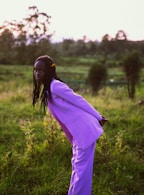 a person in a purple dress in a field