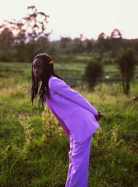 a person in a purple dress in a field