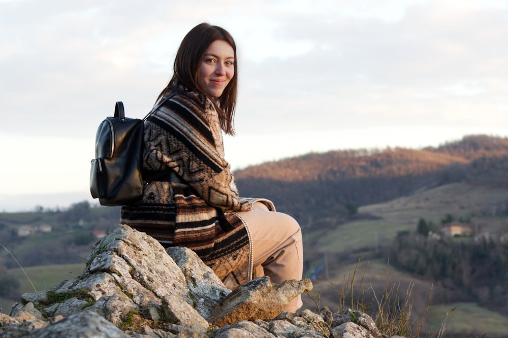 a person sitting on a rock