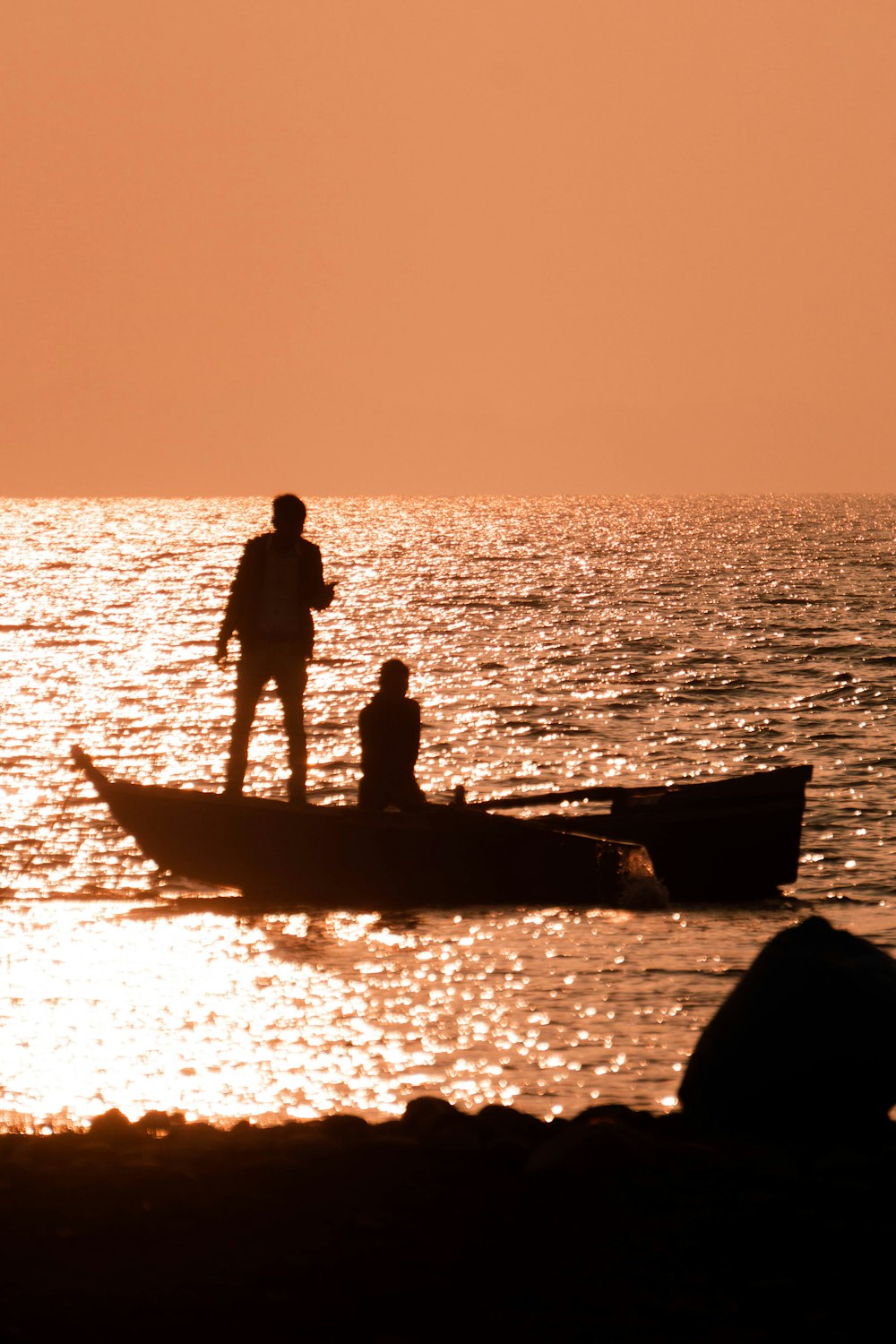 a man and a child standing on a boat in the water