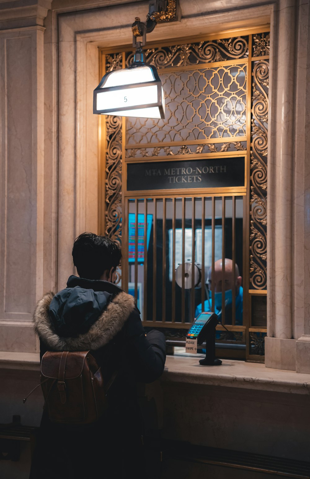 a person sitting in front of a gate