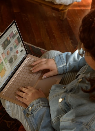 a woman sitting on the floor using a laptop computer