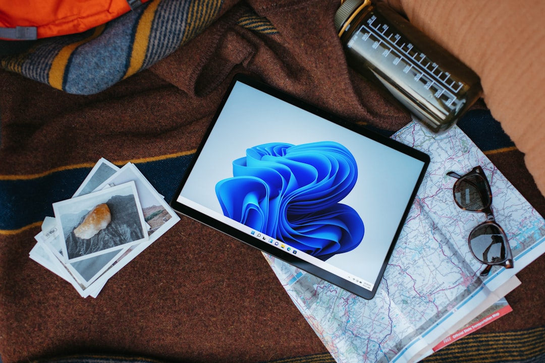 a laptop computer sitting on top of a bed,
