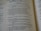 An open book displaying parts of Psalm 20 in clear and readable text. The pages are well-lit with a gentle focus, showcasing a passage with numbered verses. The text is printed in a serif font and is centered within the pages, revealing a religious context.