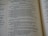 An open book displaying parts of Psalm 20 in clear and readable text. The pages are well-lit with a gentle focus, showcasing a passage with numbered verses. The text is printed in a serif font and is centered within the pages, revealing a religious context.
