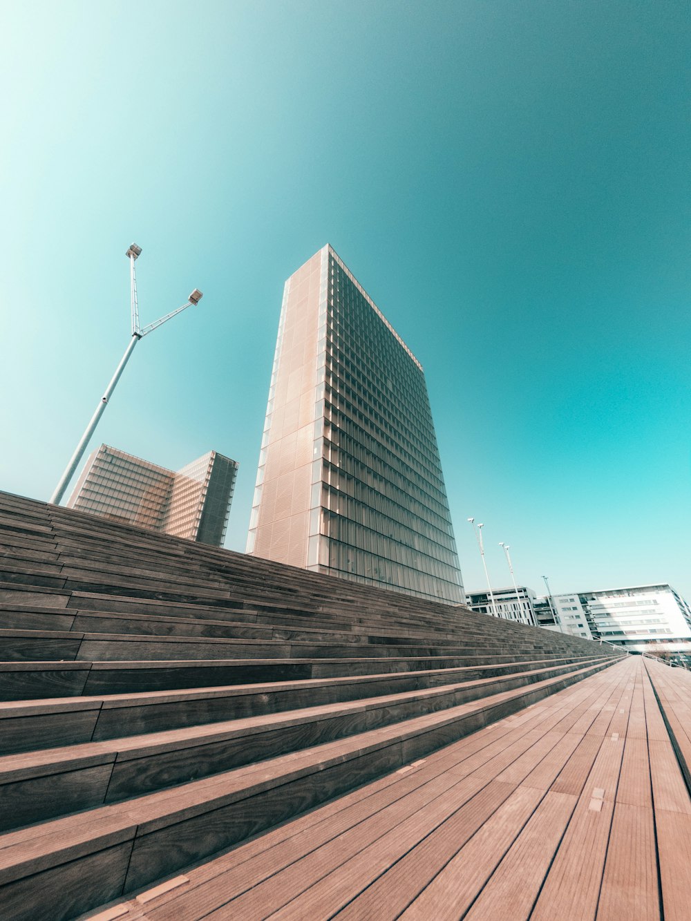 a very tall building sitting next to a wooden floor