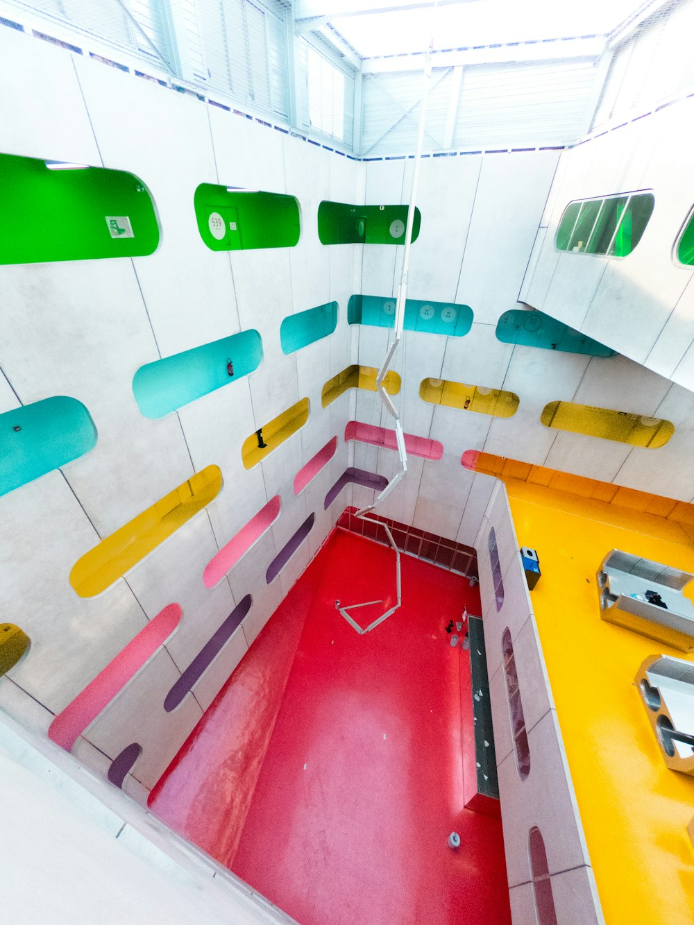 a room with a red floor and colorful walls