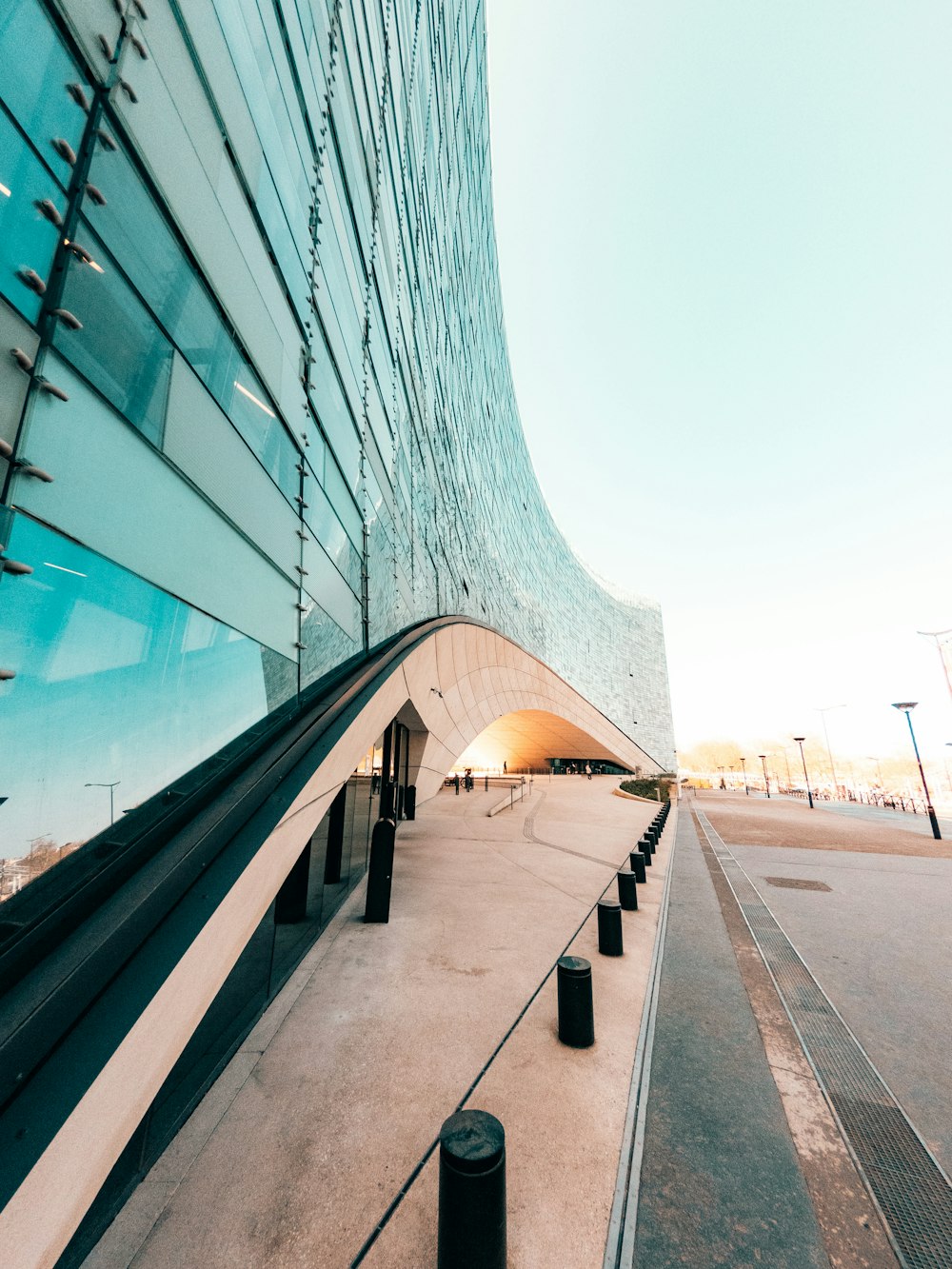 a large building with a curved walkway next to it