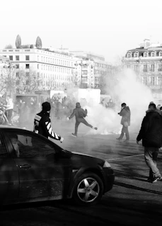 a black and white photo of people playing in the street