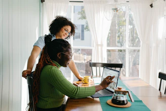 A warm, sunlit photo of a relaxed couple discussing crypto trades over coffee in a cozy, terracotta-toned room.
