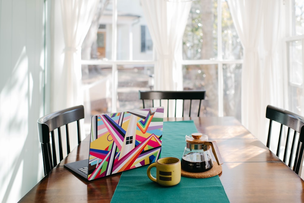 a wooden table topped with a cup of coffee