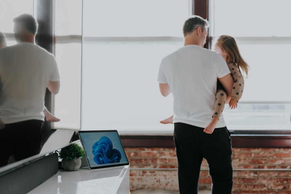 a man and a woman are looking at a computer screen