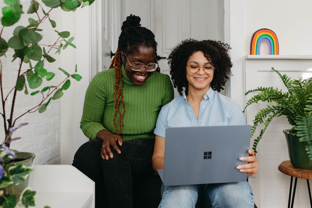 a couple of women sitting next to each other on a couch