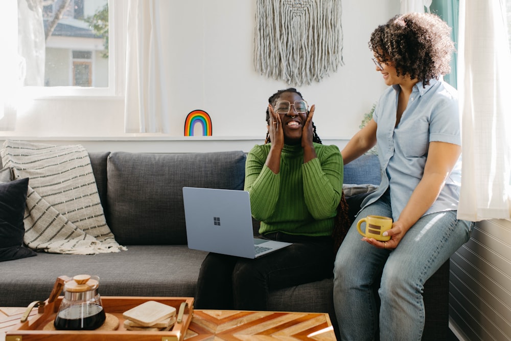 a woman sitting on a couch talking on a cell phone