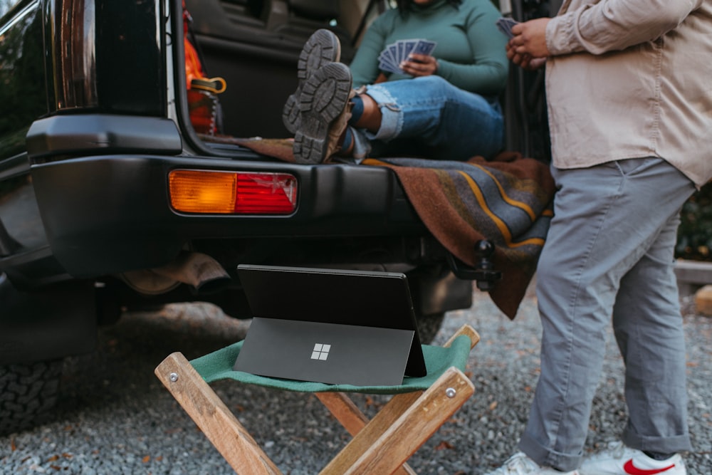 a couple of people that are standing in the back of a van