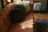 A cozy living room with a laptop streaming a vibrant radio channel interface.