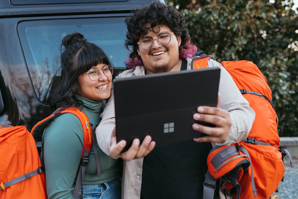 a couple of people that are looking at a laptop