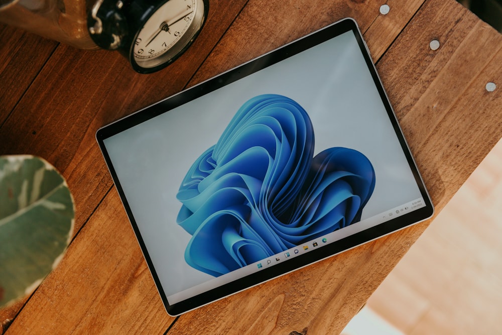 a laptop computer sitting on top of a wooden desk