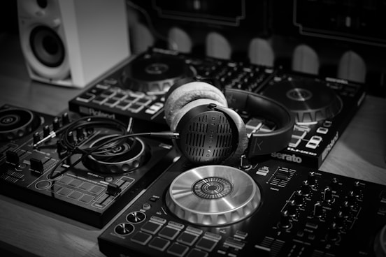 a pair of headphones sitting on top of a dj's decks