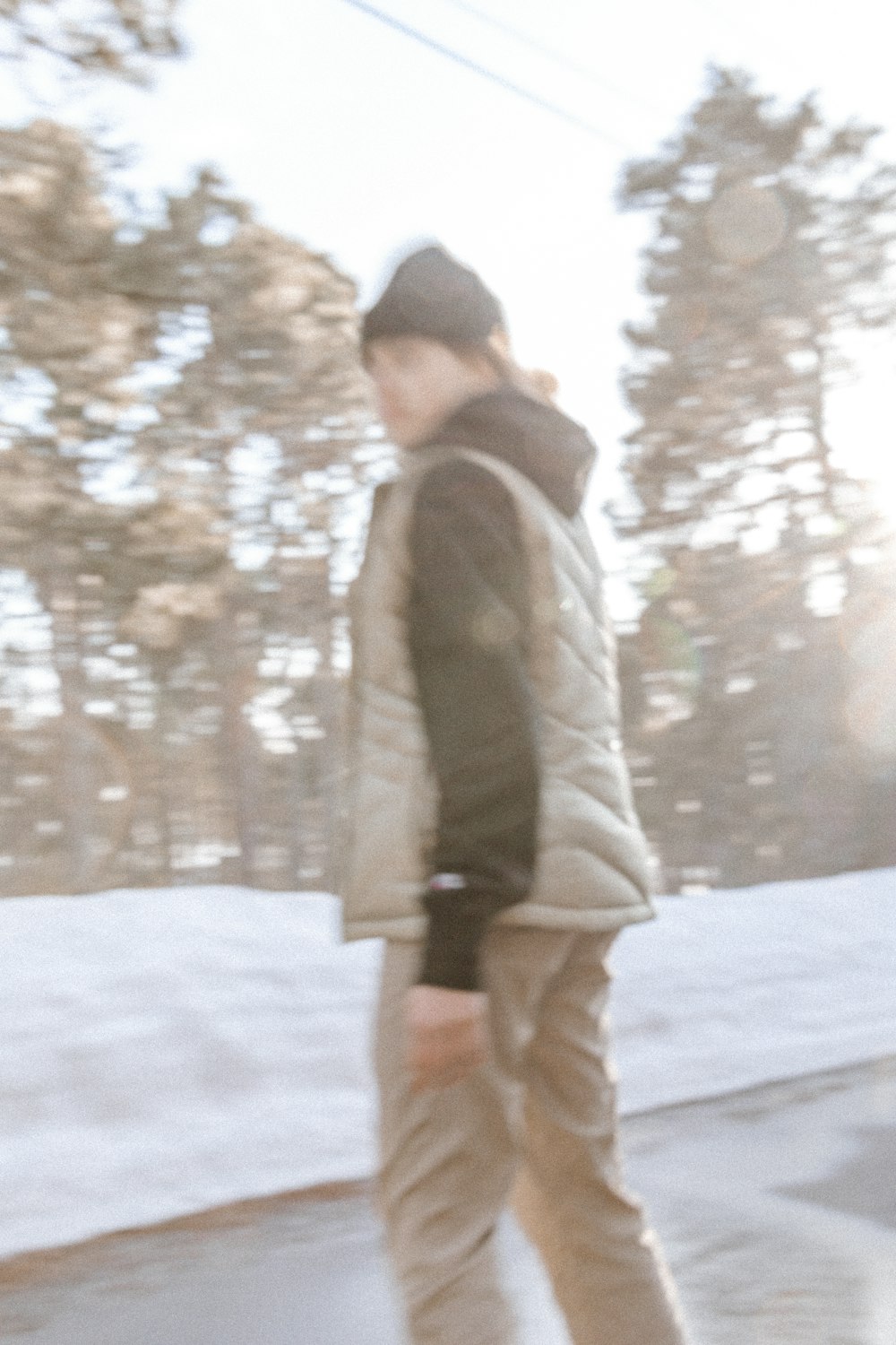 a man riding a skateboard down a snow covered slope