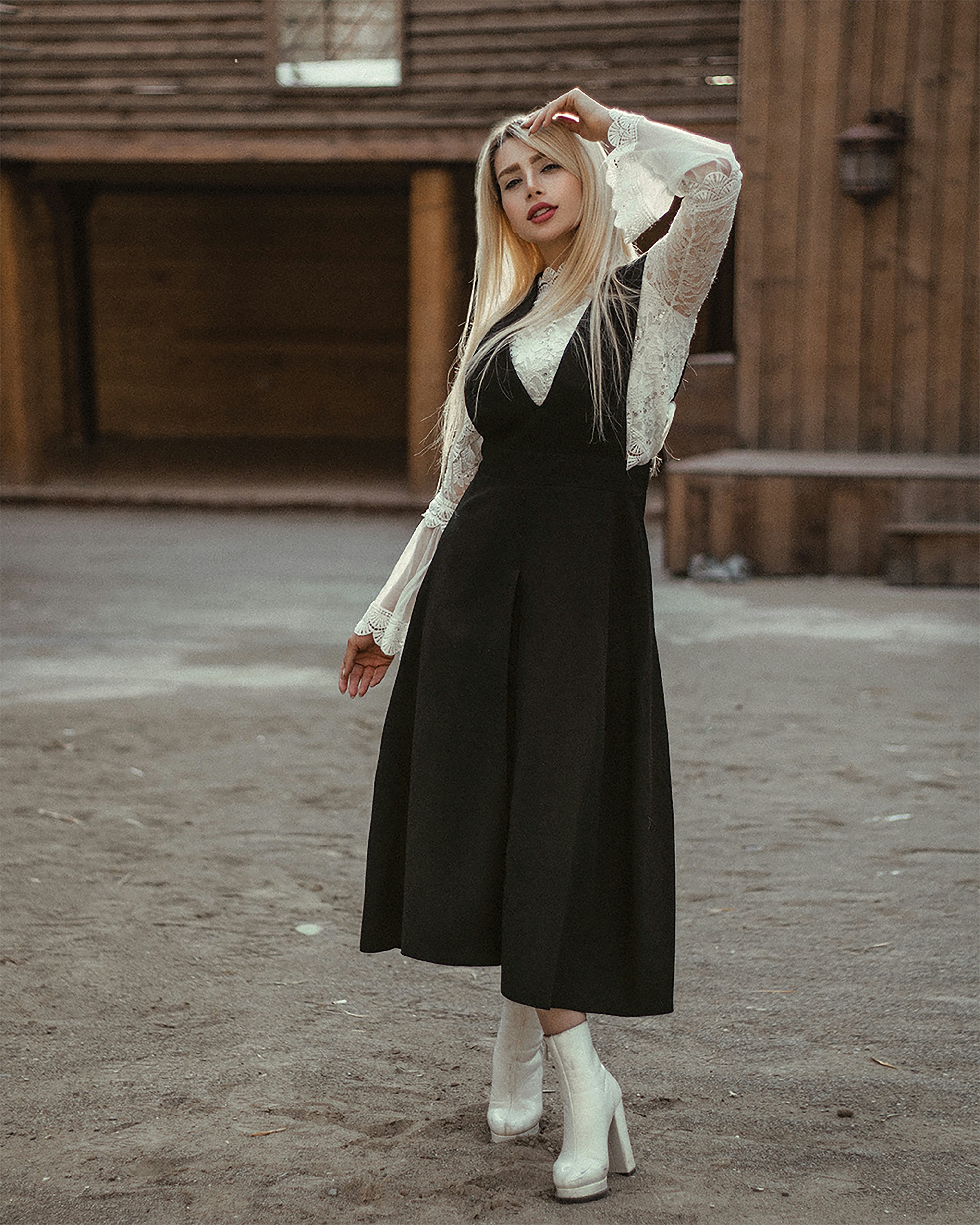 A woman wearing a black dress and white boots photo – Free Black Image ...