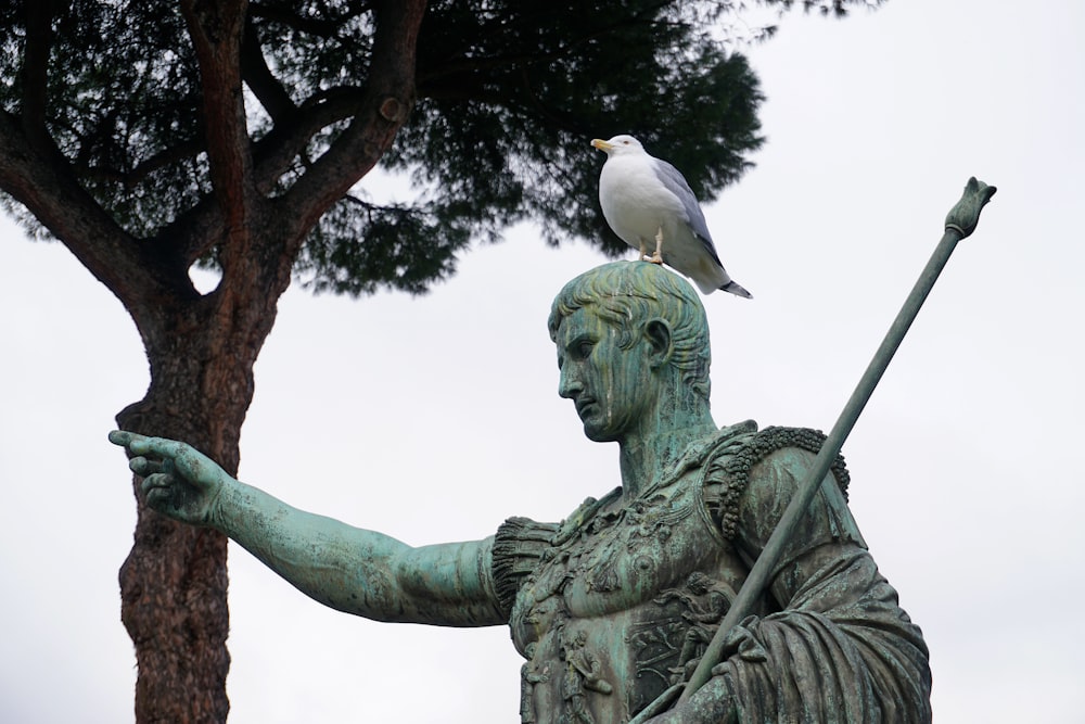 a statue with a bird perched on top of it