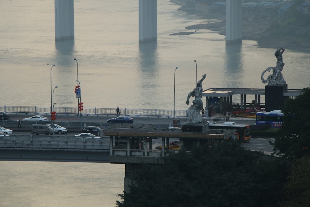 a bridge over a body of water with a statue on top of it