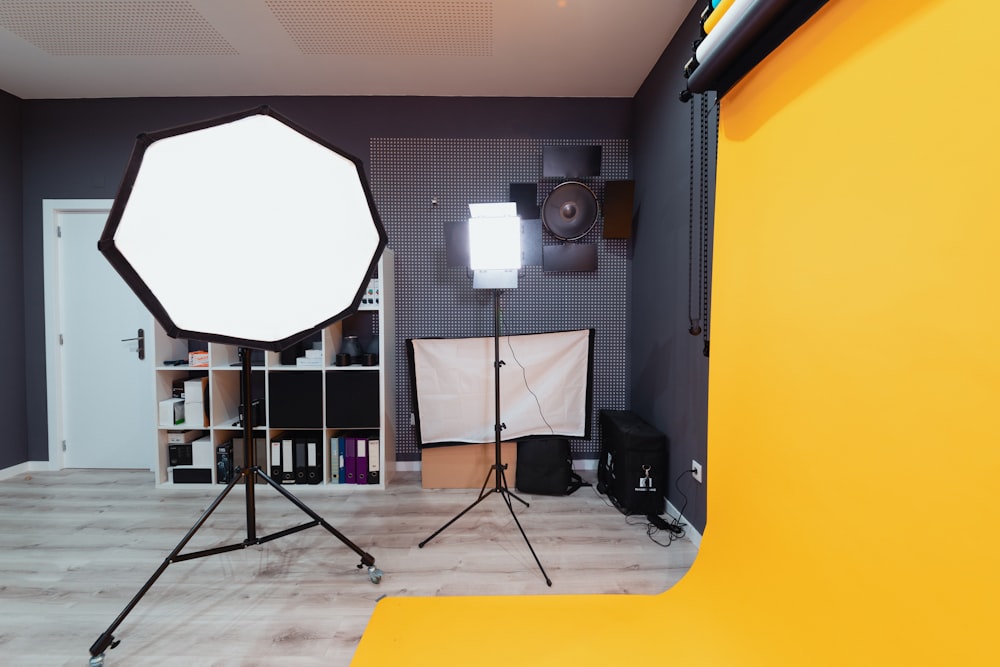 a photo studio with a light and a tripod