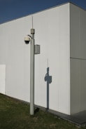 a street light next to a white building
