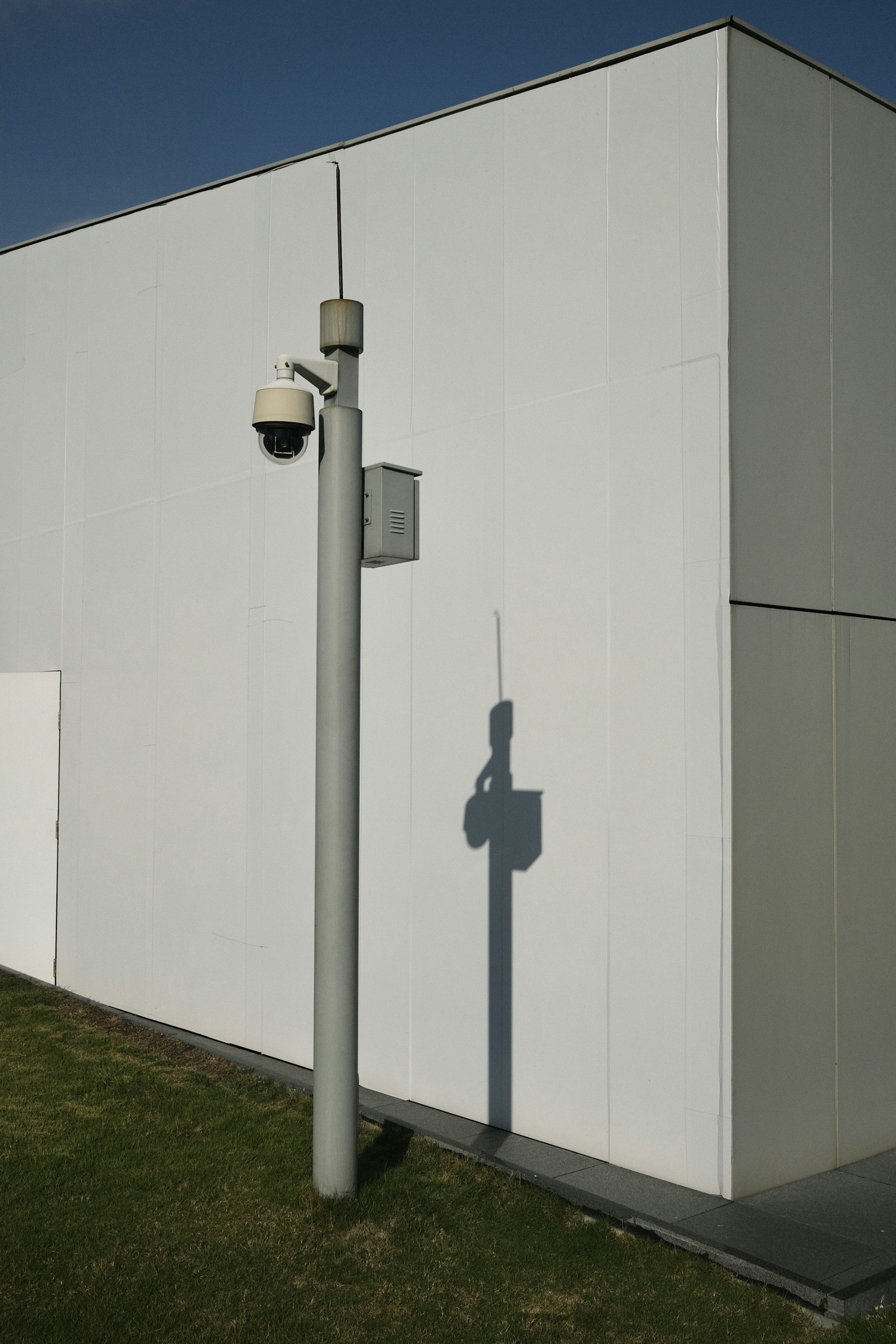 a street light next to a white building