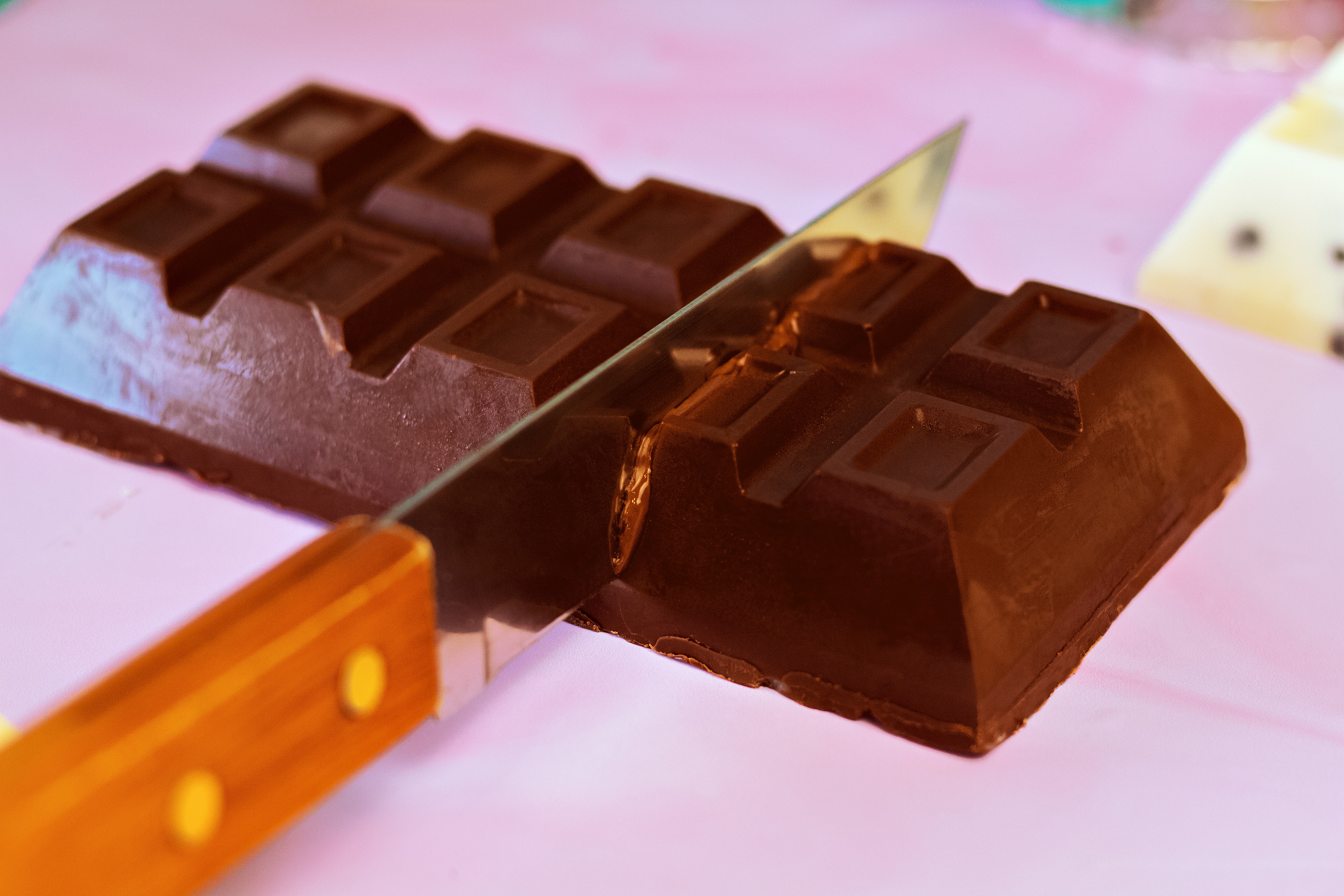 a knife cutting into a chocolate bar on a table