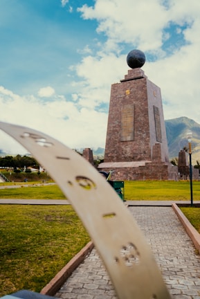 a skateboard leaning up against a monument in a park