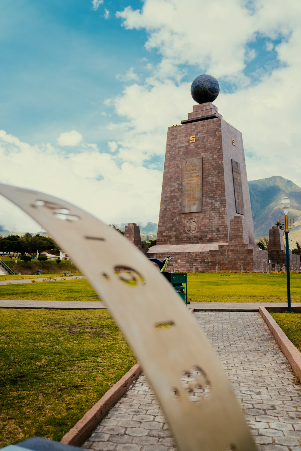 a skateboard leaning up against a monument in a park