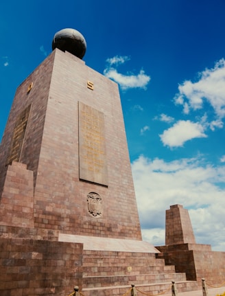 a monument in a park with a blue sky in the background