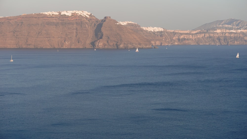 a body of water with a mountain in the background