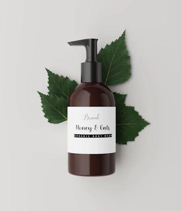 Beard wash bottle surrounded by natural ingredients like aloe and mint leaves